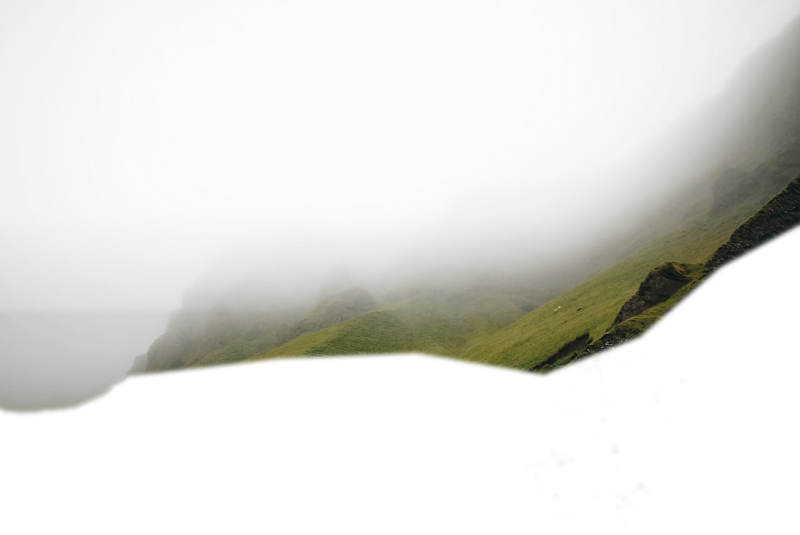 A ridge of mountains behind low cloud